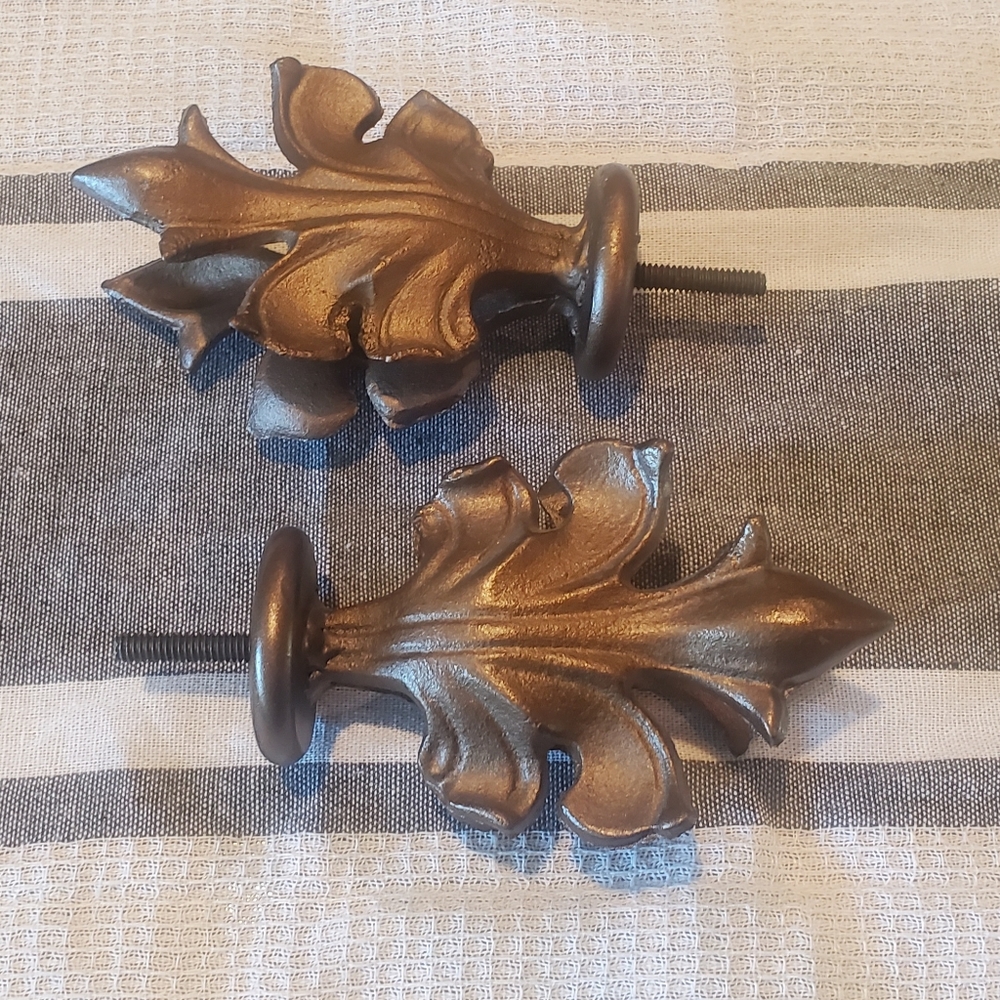 Pair of cast metal finials for drapery rods, bronze finish